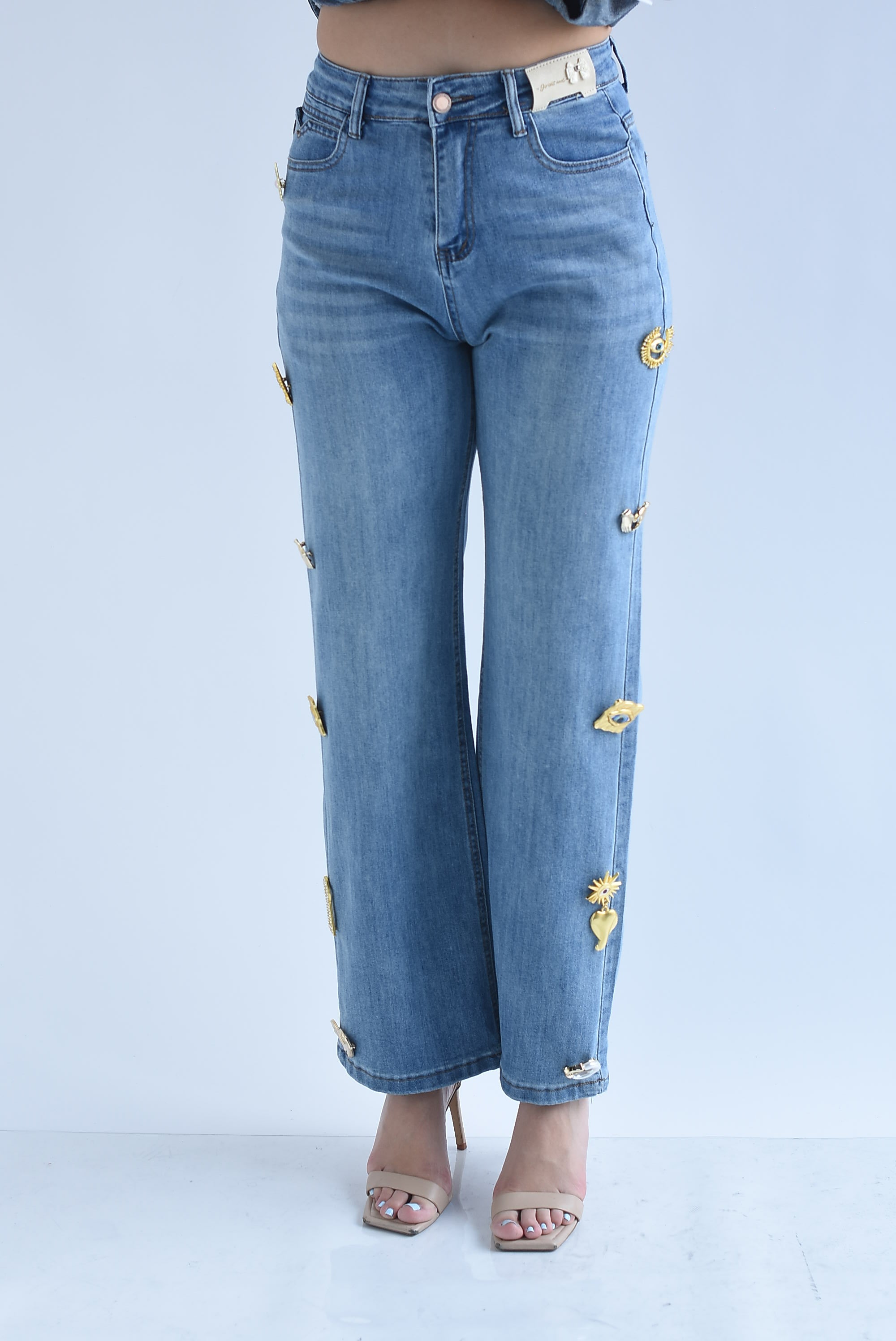 Jeans broches figuras doradas